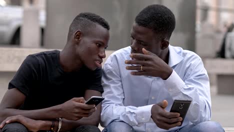 african-men-in-the-street-using-smartphon