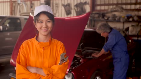 Portrait-of-a-young-beautiful-car-mechanic-in-a-car-workshop,-in-the-background-of-service.-car-service-concept.-dolly-shot