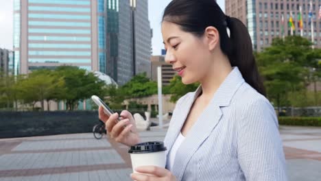 young-Asian-businesswoman-using-smartphone