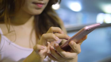 Young-Asian-Woman-Using-Smart-Phone-in-the-City-at-night