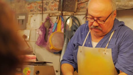 A-hispanic-man-with-a-mustache-working-in-a-fish-market-in-Mexico