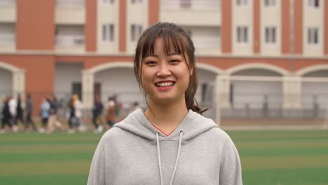 Portrait-of-young-asian-girl-smile-at-camera-in-campus