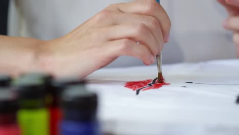 Unrecognizable-Artist-Painting-Female-Lips-on-Fabric