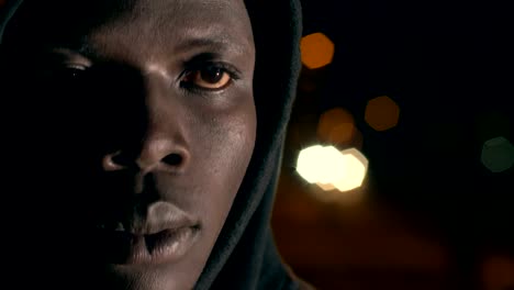 Proud-pensive-hooded-black-african-man-in-the-night-close-up