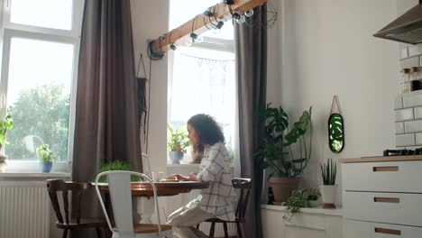 Charming-young-woman-typing-on-laptop-computer-at-home.