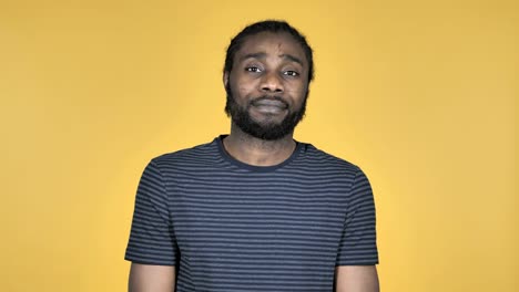 Sad-Upset-Casual-African-Man-Isolated-on-Yellow-Background