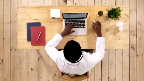 Young-African-American-doctor-at-work,-with-laptop