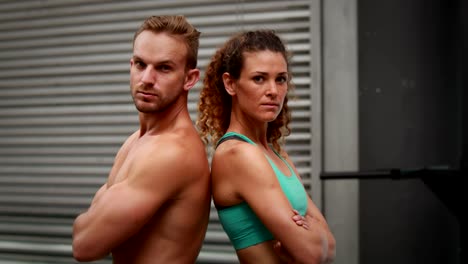 Fit-couple-posing-at-gym-gym