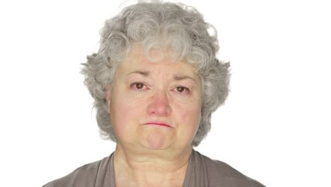 Mature-woman-fights-back-tears,-on-a-white-studio-background