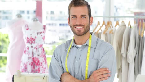 Handsome-fashion-designer-smiling-at-camera-with-arms-crossed