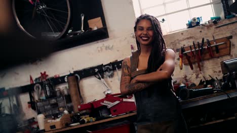 Afro-craftswoman-standing-in-her-workshop-with-her-tools