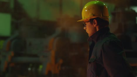 Portrait-of-Heavy-Industry-Technician-Putting-on-Hard-Hat.-Rough-Industrial-Environment.