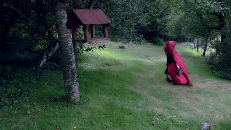 4k-Halloween-Shot-of-Red-Riding-Hood-Walking-in-the-Forest