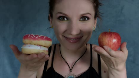 4k-Shot-of-a-Woman-Posing-in-Studio-with-Donut-and-Apple