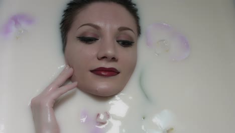 4k-shoot-of-a-model-face-in-white-water-and-flowers