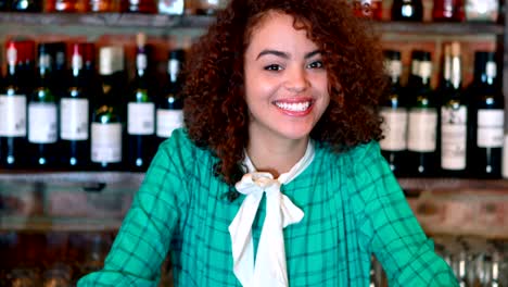 Portrait-of-barmaid-smiling-at-bar-counter