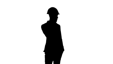 Silhouette-Auftragnehmer-in-Bauarbeiterhelm-auf-seinem-Handy-zu-sprechen