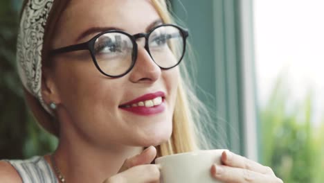 Schöne-junge-Frau-trinken-Kaffee-im-Café.-Mädchen-träumen.-Frauen-mit-Brille.