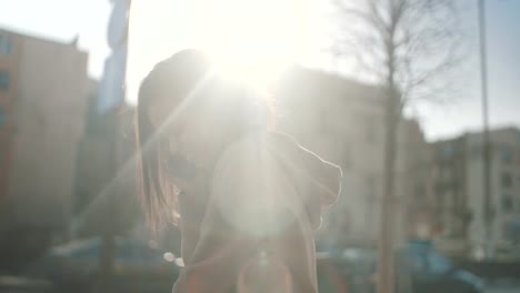 Portrait-of-young-African-American-woman-using-phone,-outdoors.