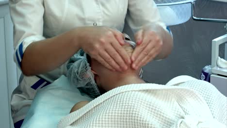 Young-woman-at-a-spa-getting-facial-and-neck-massage