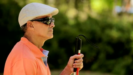 Portrait-Of-Blind-Man-Sitting-In-City-Park