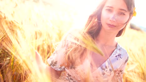 Retro-romantic-woman-touching-golden-heads-of-wheat-in-field