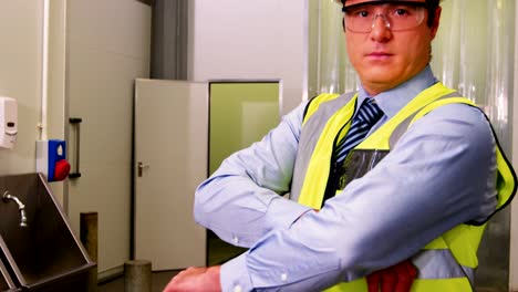 Portrait-of-inspection-officer-standing-with-arms-crossed