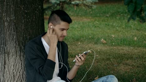 Young-handsome-man-listening-to-music-on-headphones