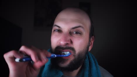 4K-Man-Looking-in-Mirror-and-Brushing-Teeth