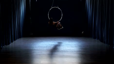 Charming-acrobats-performs-a-trick-in-the-aerial-hoop