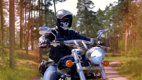 Portrait.-A-man-in-a-skull-mask-sits-on-a-bike.