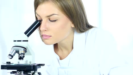 Female-Chemist,-Scientific-Reseacher-using-Microscope-in-Laboratory