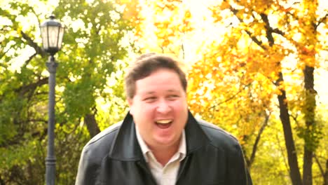 Happy-fat-man-laughs-in-the-Park.-Portrait