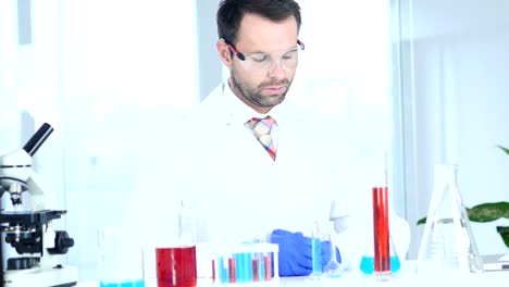 Scientific-Reseacher-Sitting-in-Laboratory,-Microscope