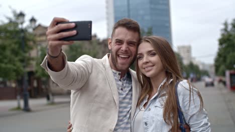 Loving-Young-Couple-Talking-Selfie-with-Smartphone