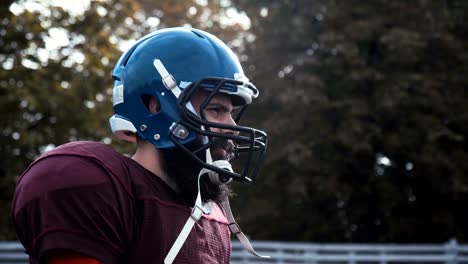 Man-putting-helmet-before-American-football-match