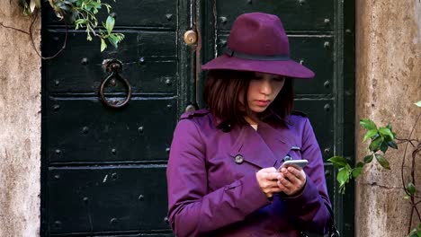 elegant-Chinese-woman-typing-on-the-smartphone-in-the-street,-portrait