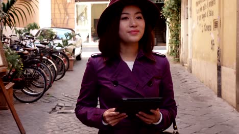 Chinese-young-Woman-Using-Digital-Tablet-And-Smiling--outdoor