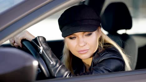 Beautiful-model-sitting-inside-of-new-car-looking-confidently-away