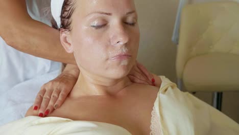 Attractive-female-at-spa-health-club-getting-a-facial-massage