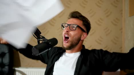 crazy-radio-DJ-shouting-and-throws-papers-into-air-in-studio
