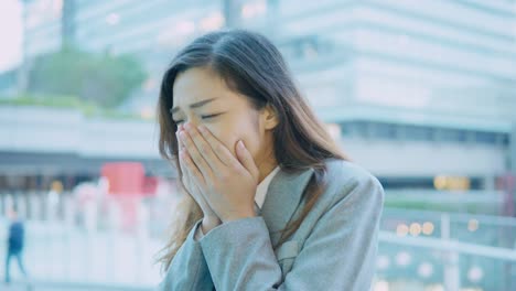 business-woman-coughing-and-sneezing-at-outdoor-in-the-city