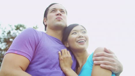 Young-male-female-ethnic-couple-laughing-together-outdoors