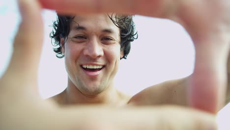 Asian-Chinese-male-fingers-framing-smiling-self-portrait