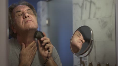 Senior-man-shaving-his-beard-in-bathroom