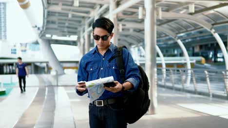 The-handsome-man-check-point-on-paper-map-in-city-before-walking