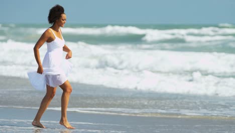 Portrait-of-woman-with-afro-hair-on-beach