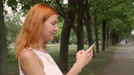 Redheaded-woman-texting-on-mobile-phone.