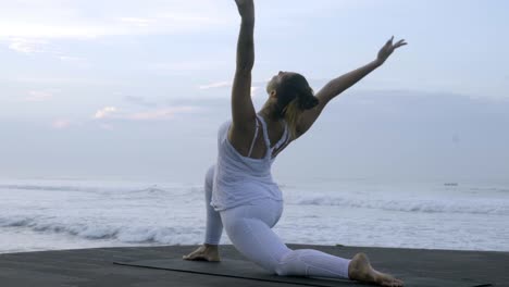 Woman-Doing-Low-Lunge-Pose-on-Beach