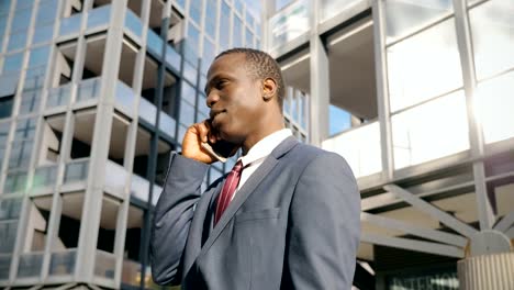 Portrait-of-self-confident-black-african-business-man-talking-by-phone